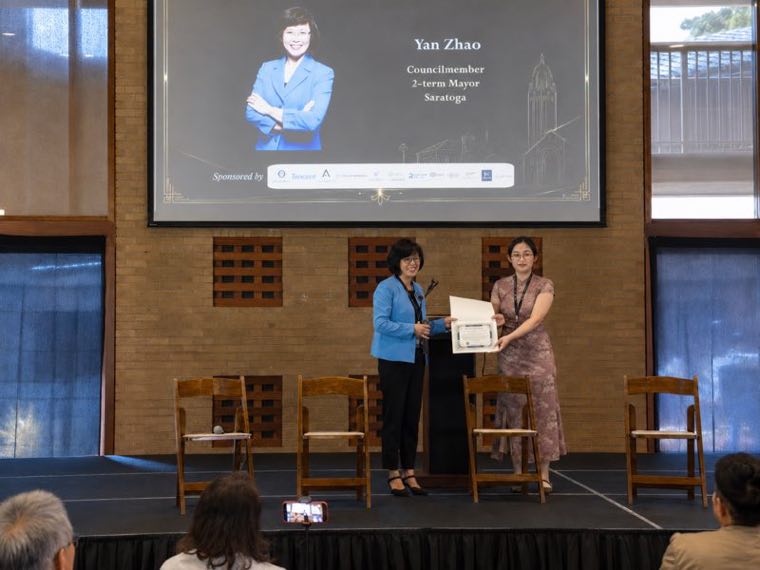 Councilmember Yan Zhao presenting a certificate